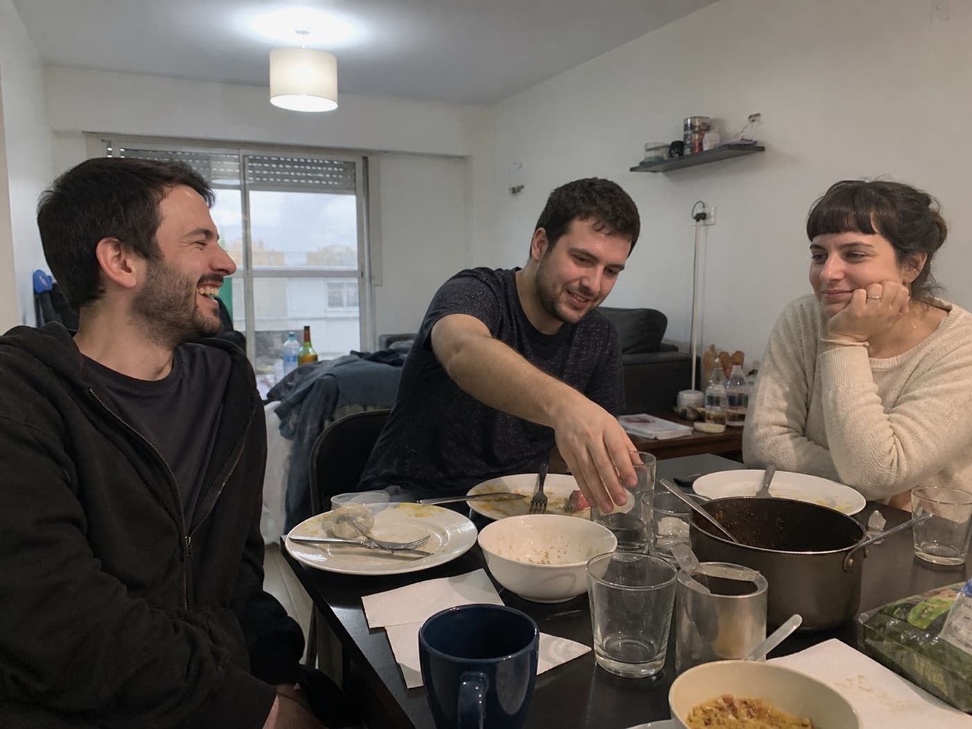 Three friends finishing dinner together.